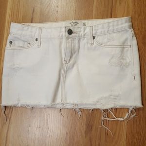 Distressed white jean mini skirt